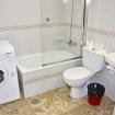 Bathroom with washer, bathub & shower Apartment 313 Playa Dorada